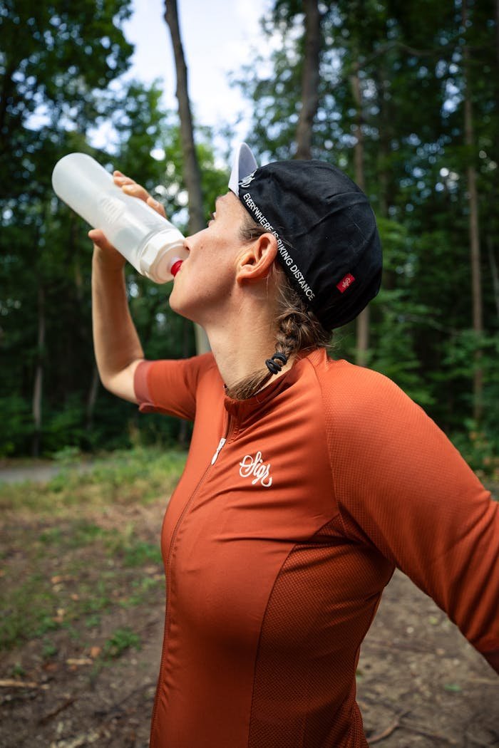 A Woman Drinking Water From  a Jug